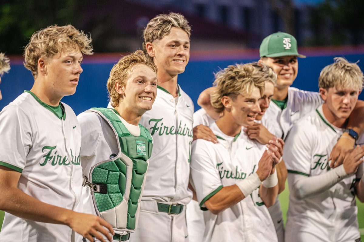 Arm in arm, the Varsity Baseball team celebrates their win at 6A Kansas State Championship. They won 7-1 against Shawnee Mission West on Friday, May 30.