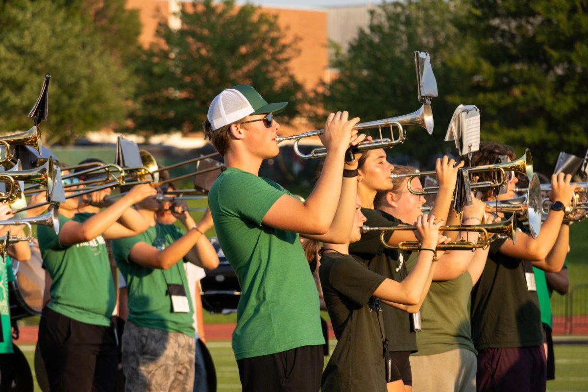 Playing the trumpet, junior Logan Simons participates in the band camp performance on Aug. 5. 
