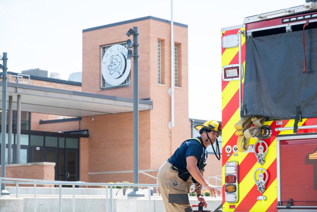 Outside of Lawrence High School, a firefighter checks on the condition of the school.