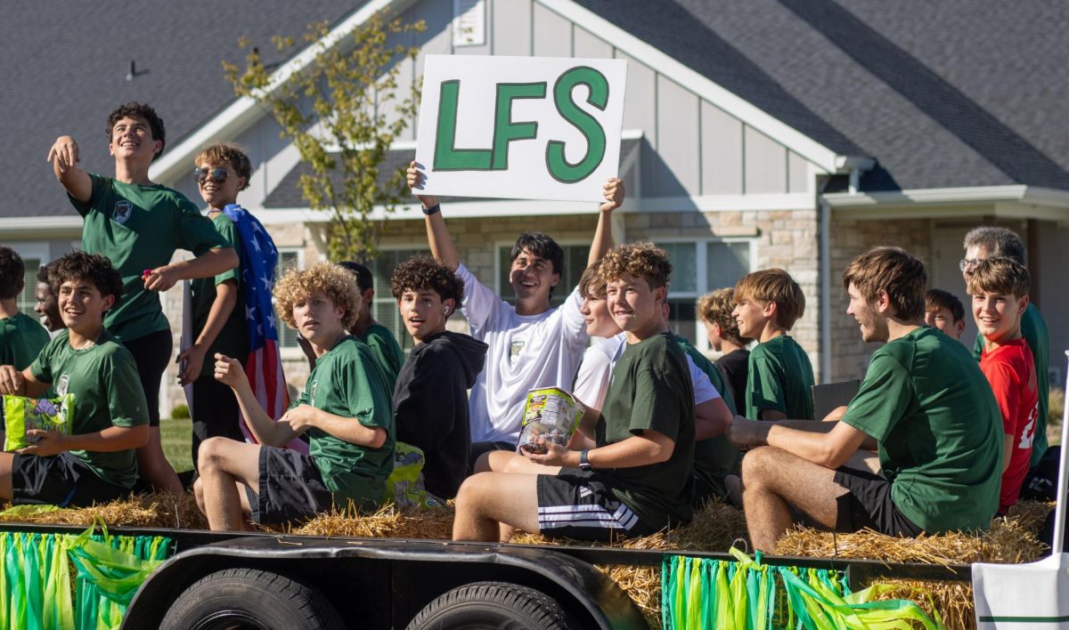 Members of the Free State Soccer team engage with the crowd in the homecoming parade.