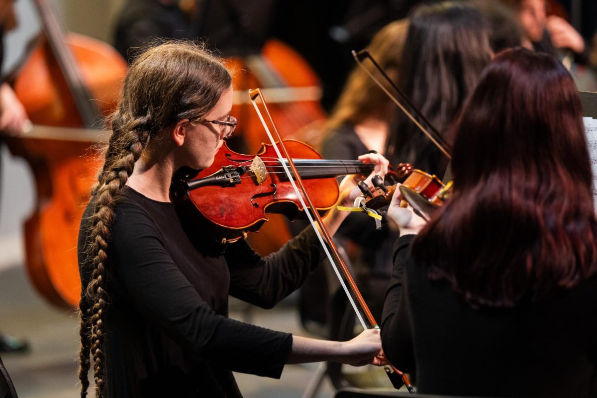 Rebecca Gale, junior, plays violin in Philharmonic Orchestra during the fall concert.