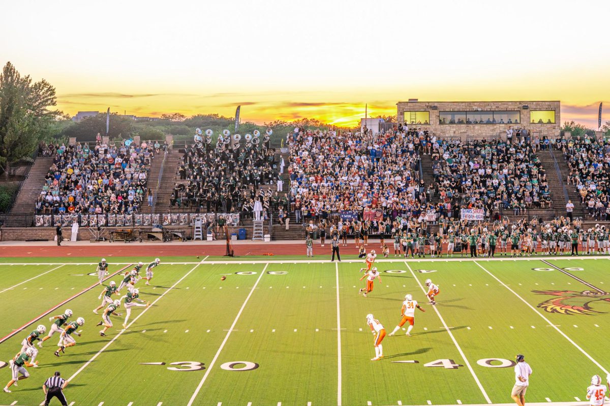 Starting the game, junior Micah Jones kicks the ball.
