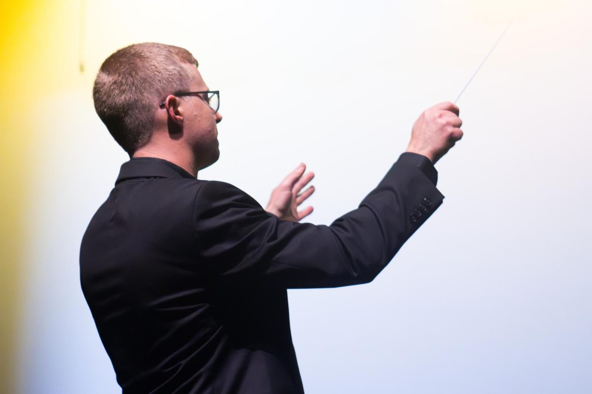 Conducting the concert, band teacher Michael Solomon leads the band on Oct. 6. 