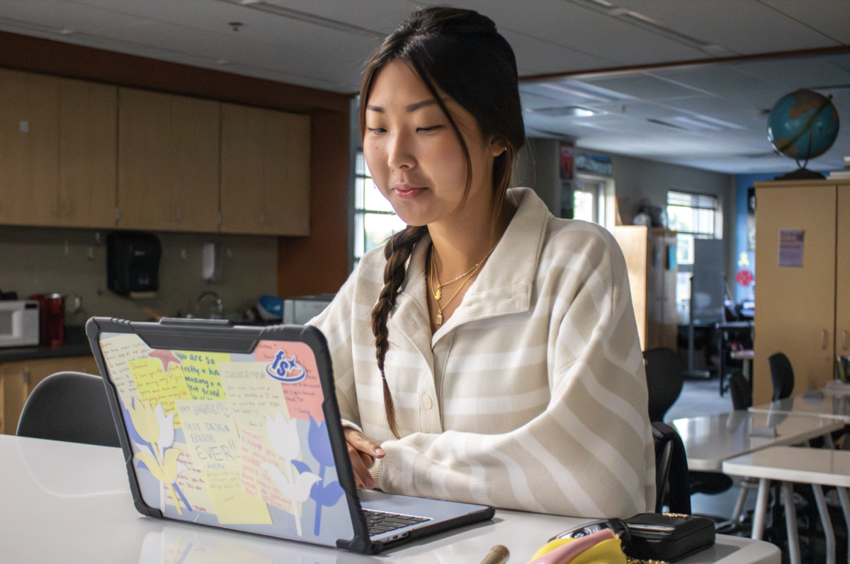 Typing away, senior Jaehee Kim does homework on her MacBook.