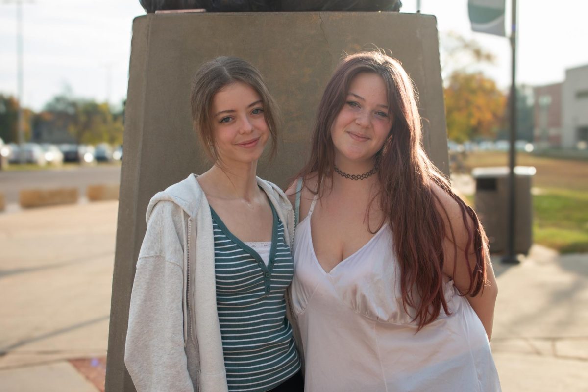 Standing below the firebird statue, news editor-in-chief and seniors Evie Chancy and Maria Mosconi pose.