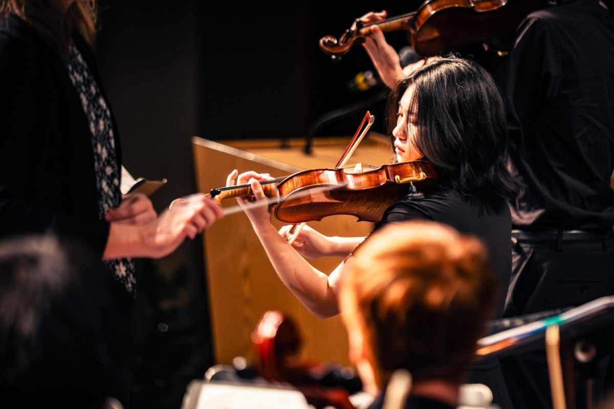 Playing her violin, senior Kianna Ayala performs as first chair at the winter orchestra concert.