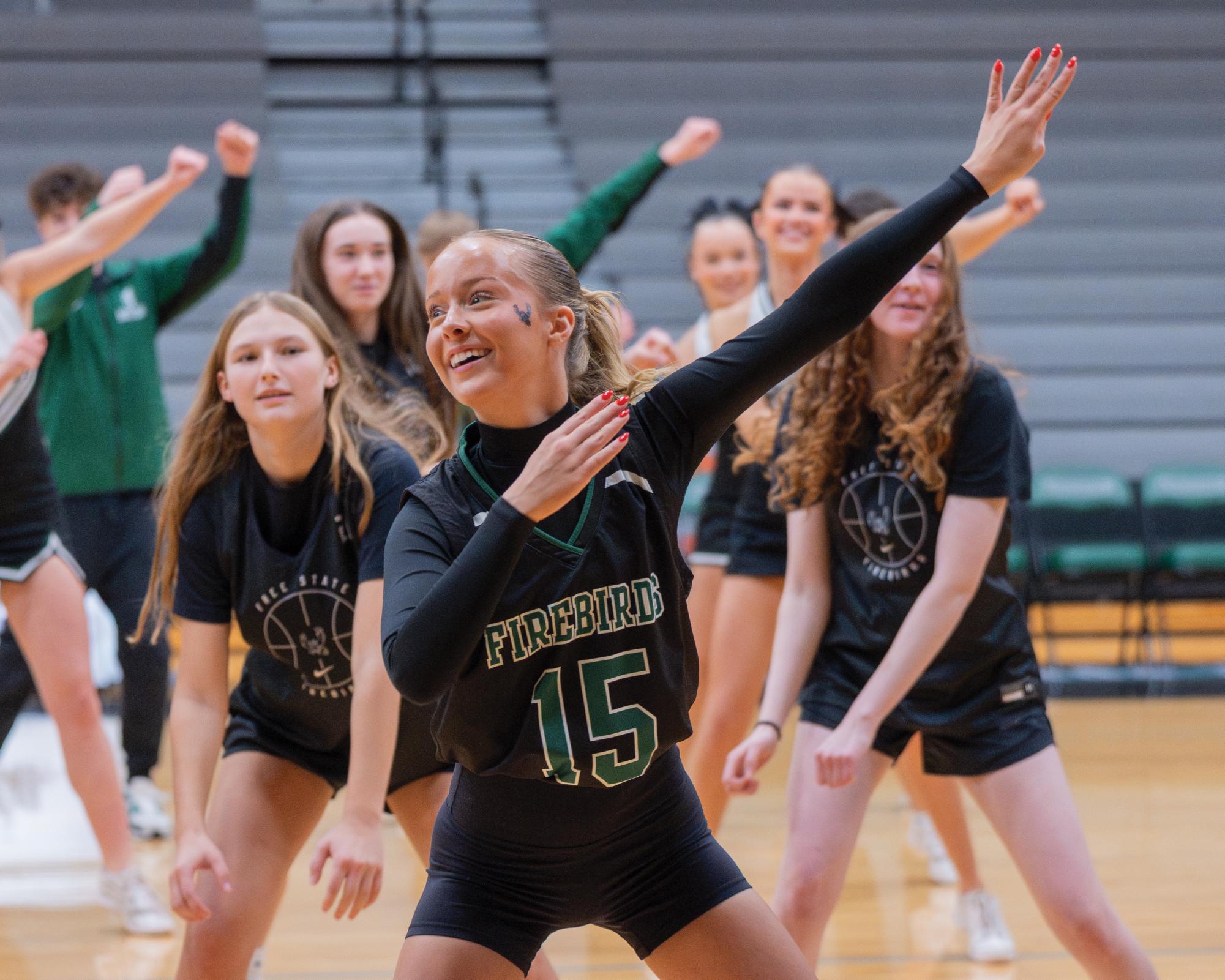 Swaying, senior Corinne Kingsley performs with the winter sports athletes.