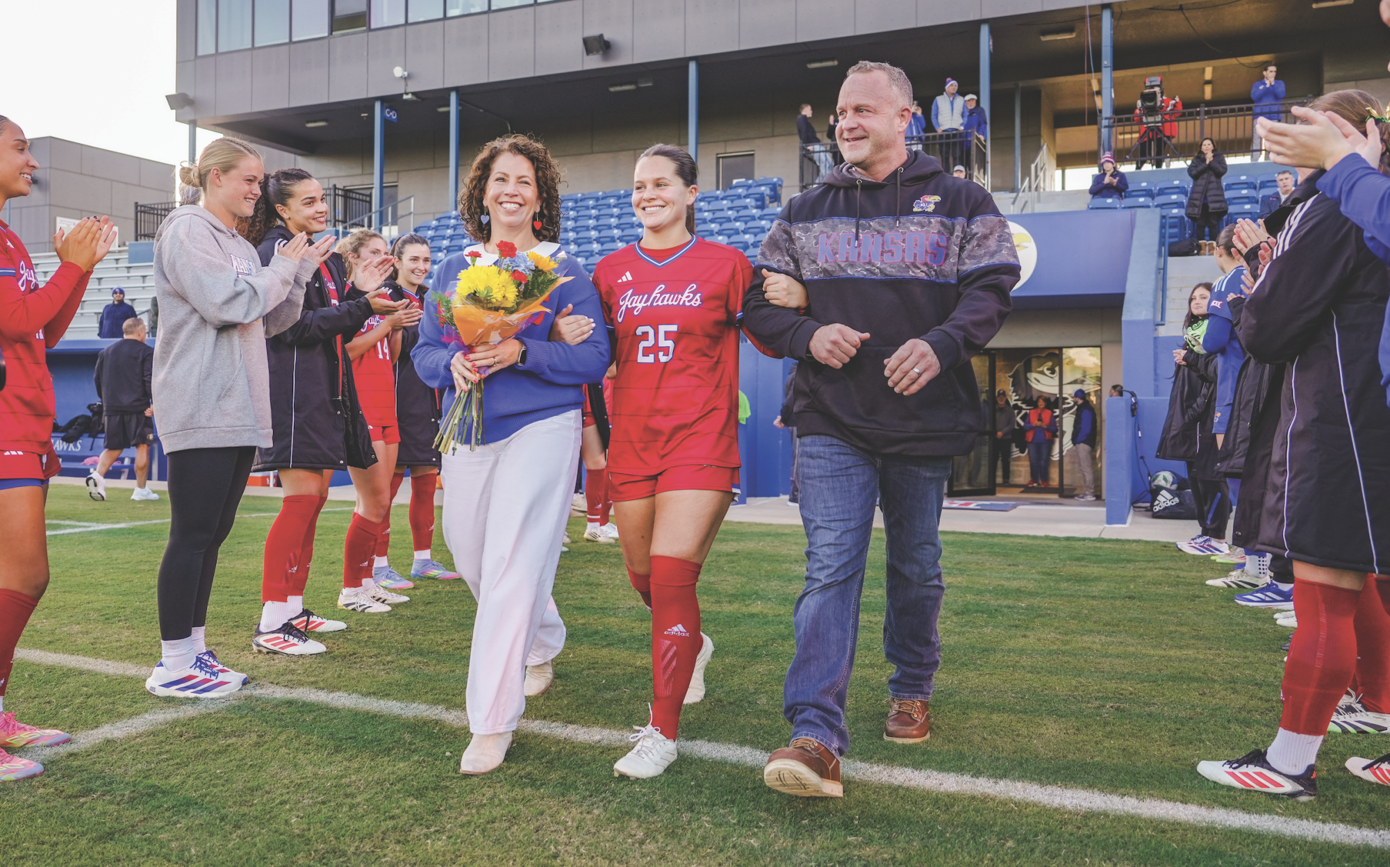Walking with her parents, University of Kansas midfielder Mackenzie Hammontree receives Senior Night recognition before a women’s soccer match against the University of Colorado Boulder on Oct. 30. 