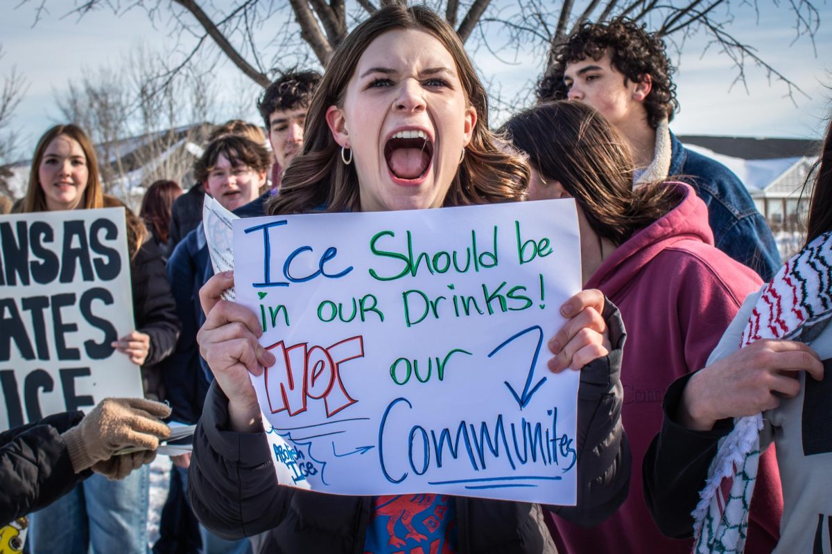 Holding up a sign, sophomore Cleo Green yells at the ICE walkout on Jan. 27. “I chose to walk out because I believe that what ICE is doing is inhumane and it needs to be addressed,” Green said. “Their use of excessive force and abuse of human rights is sickening and should be put to an end.”