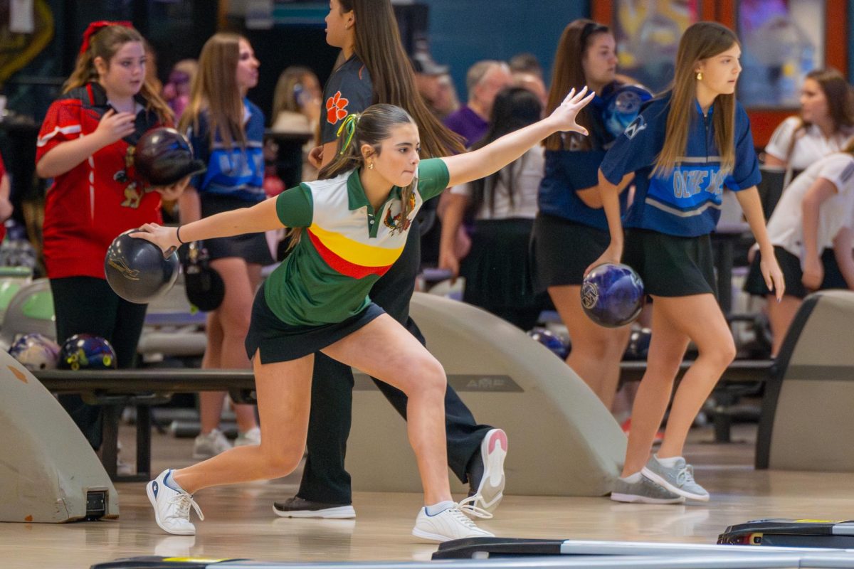 About to throw, freshman Leah Wilson bowls at Royal Crest Lane's at a home bowling meet on Jan. 15. Wilson was one of two Sunflower League Bowlers of the Year.