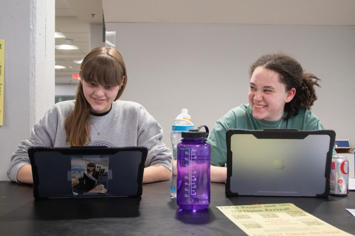 Hosting the forensics home tournament, senior Breahna Randall and sophomore Sophia Dietze smile together. 
