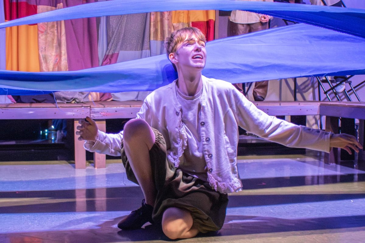 Under the water, freshman Coleman Hodges, as Peter, tries to swim.