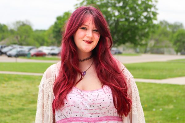 Posing, news editor-in-chief senior Evie Chancy smiles for the camera.