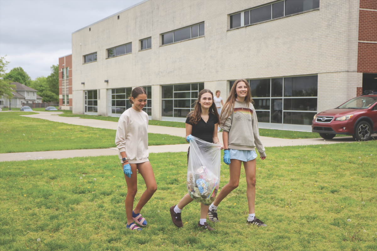 After picking up trash, freshmen Elena Salazar, Rosella Betancourt and Avery Koester walk back to the school after a Project Pickup meeting.